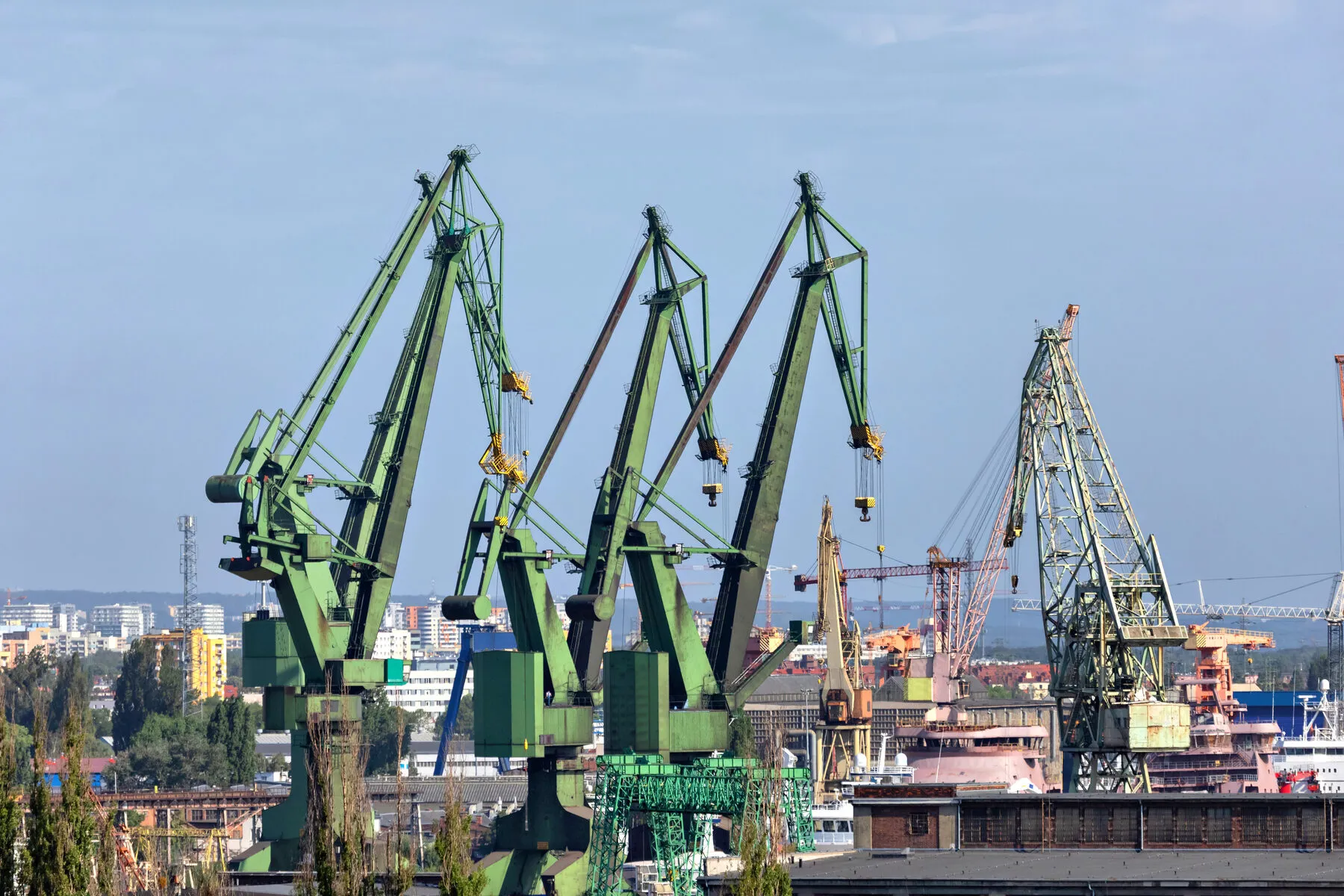 Shipyard cranes over the waterfront (illustrative)